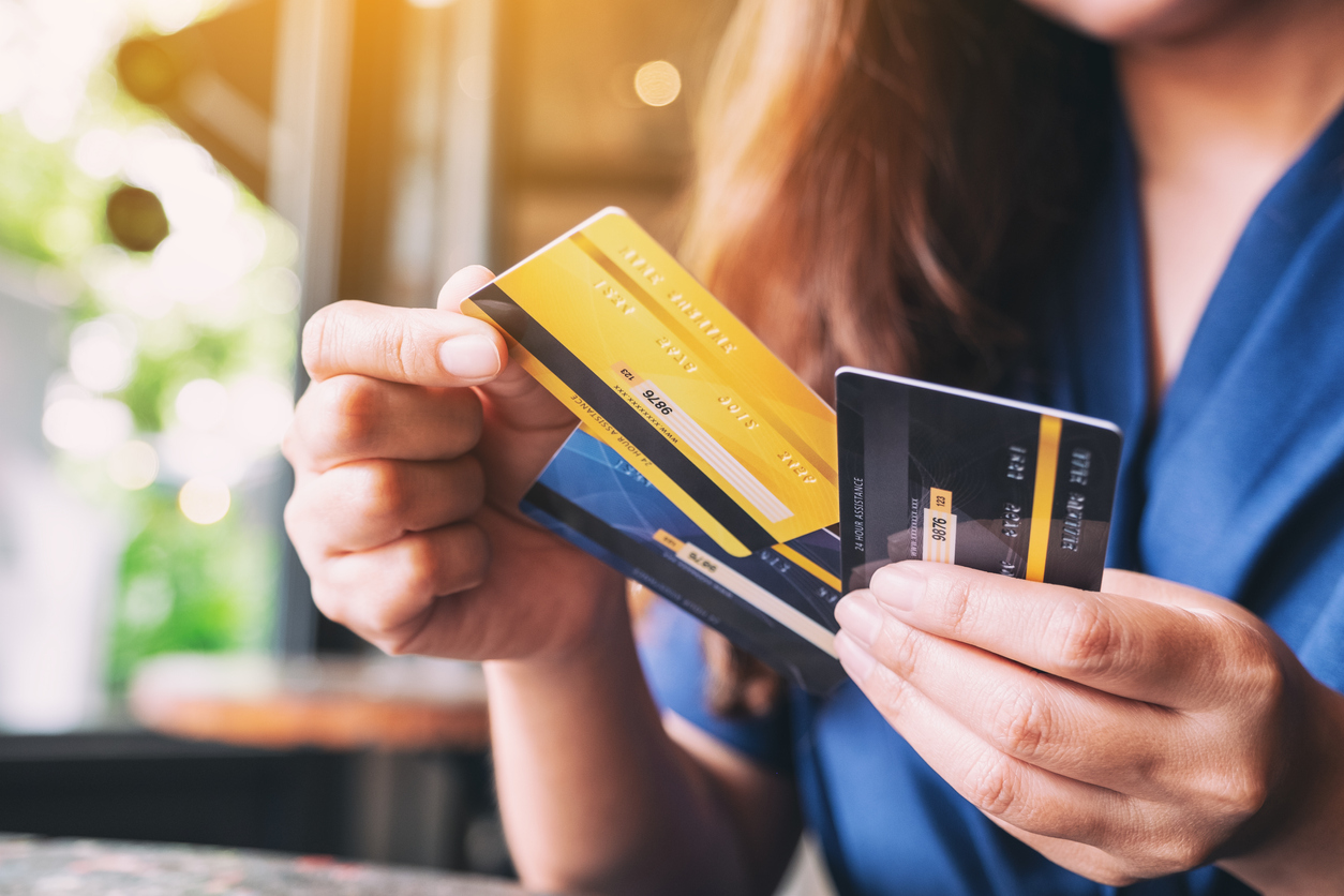 Woman holding her credit cards at the store.